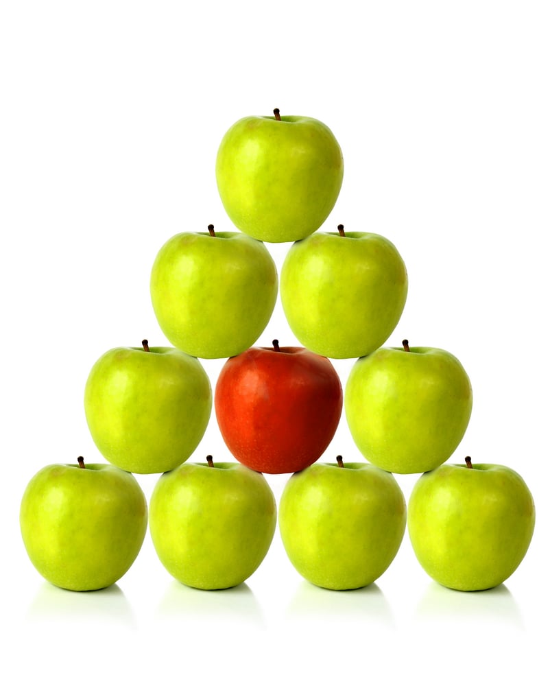 green apples on a pyramid shape over a white background-1