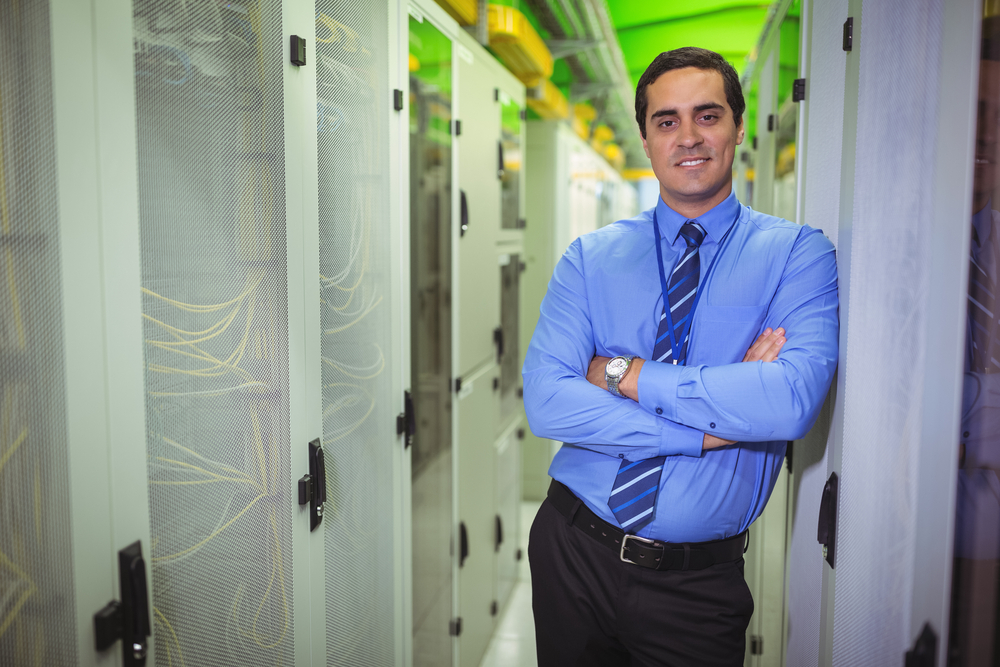Portrait of technician standing with arms crossed in a server room